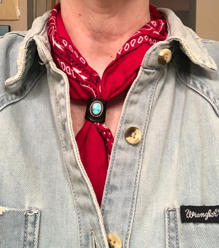 Customer photo wearing turquoise and sterling silver black leather bandana slide on a red bandana.