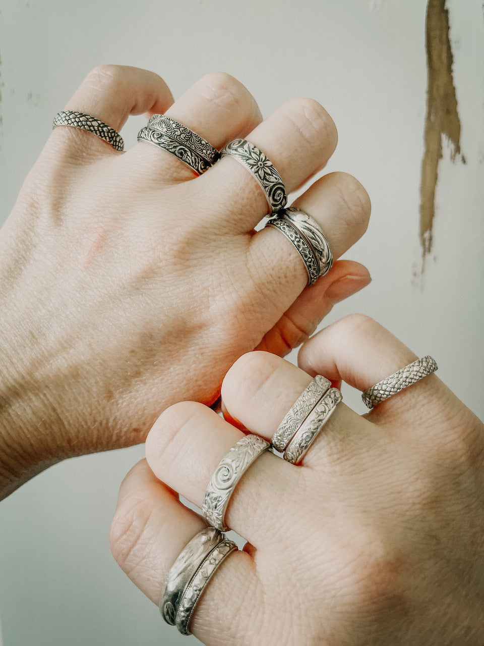 Stacking rings shown on hands. All statement stacking rings are hand-forged with .925 sterling silver with beautiful engravings.