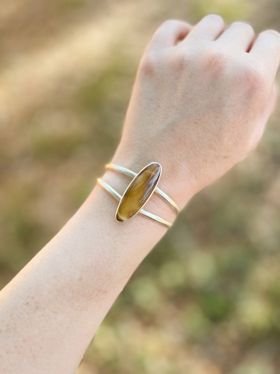 Treasure Mountain Turquoise Silver Cuff Bracelet - worn on wrist outdoors.