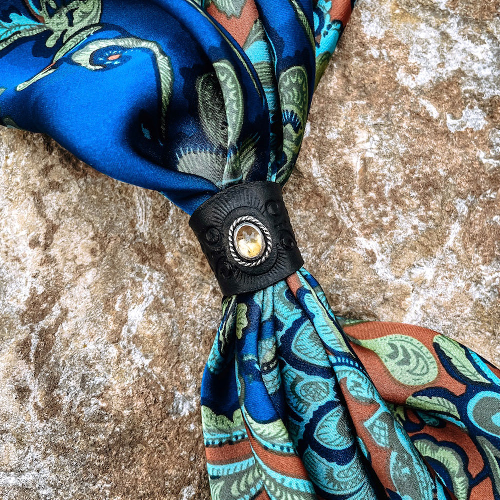 Citrine Leather Bandana Slide - round yellow citrine stone set in sterling silver with rope band on black stamped leather slide on blue and orange silk bandana.