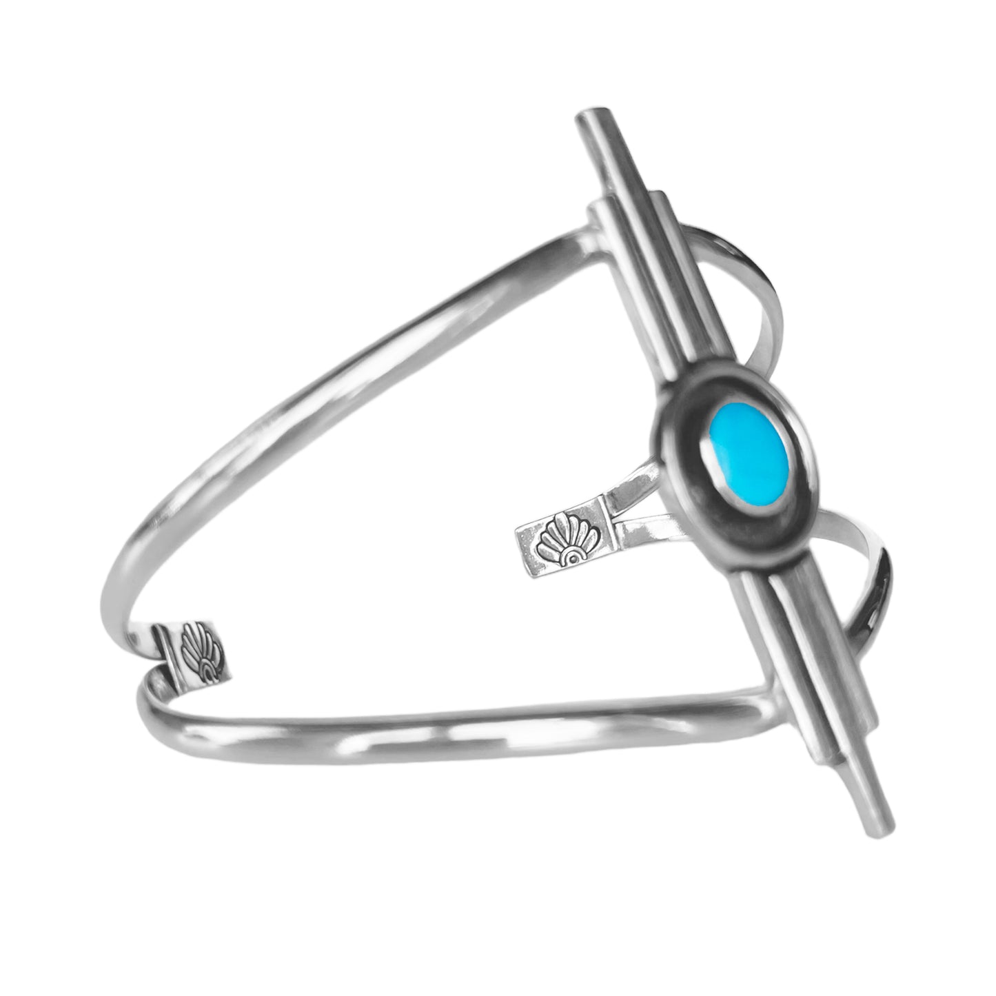 Art Deco inspired sterling silver cuff bracelet. The focal is a 3 bar design with the middle bar slightly longer than the 2 side bars. The middle contains a round turquoise stone encircled with a black patina. The cuff features a double band with stamped accents on the ends. Side view of cuff.