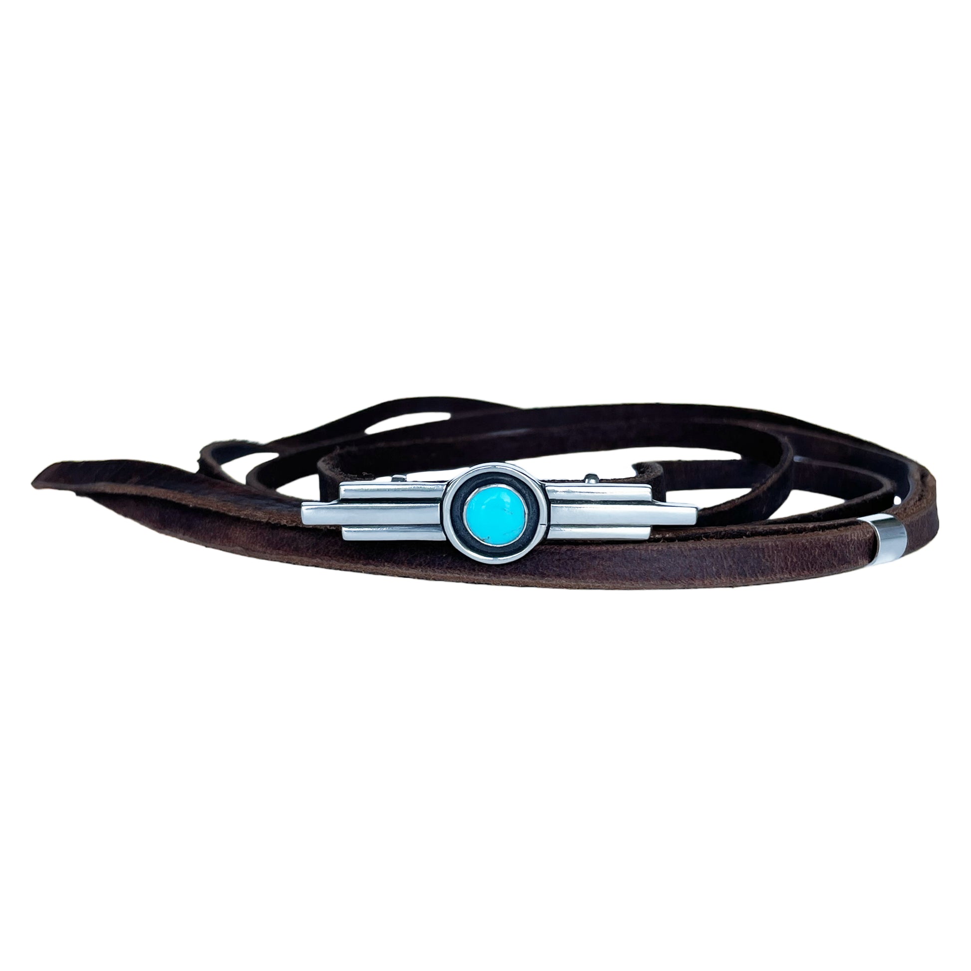 Thin brown leather hat band featuring a sterling silver hat pin with 3 bar design with the middle bar slightly longer than the 2 side bars. The middle contains a round turquoise stone encircled with a black patina.